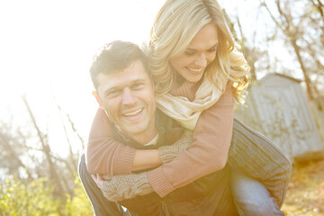 Happy, piggyback and couple with portrait in nature for outdoor adventure, romance or love in morning. Man, woman and smile with affection in woods for anniversary, weekend break or tourism in Norway