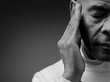 © herlanzer - deaf man suffering from deafness and hearing loss on grey background with people stock image stock photo