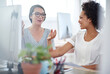 © peopleimages.com - Women, people and happy in office on computer with conversation or discussion as graphic designer. Business, employees and smile with chat for meeting, brainstorming and unity for project or task
