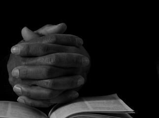 praying to god with hands together on black background with people stock image stock photo	