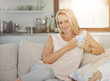 © Y.A./peopleimages.com - Mature, woman and portrait with tea on sofa for relax, wellness and weekend break with comfortable in home. Person, happy and drinking coffee on couch in living room with smile, peaceful and beverage