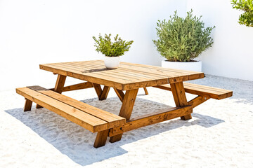 Wall Mural - Wooden picnic table on white sand beach