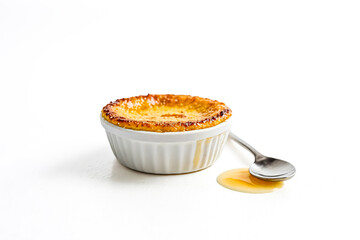 Wall Mural - Delicious Creme Brulee Dessert with a Spoon and Drizzled Caramel