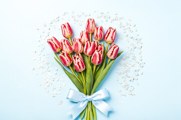 Wall Mural - Pink and white tulips with blue bow on a light blue background