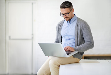 Poster - Laptop, research and man on desk in office for it support in startup company for project. Working, read and male software engineer with computer for troubleshooting online for could computing systems