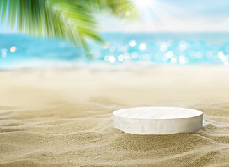 Wall Mural - Sunny beach with round pedestal on golden sand under palm tree with ocean in background