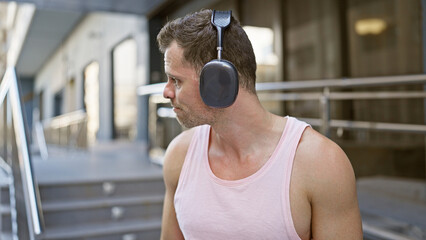 Poster - Handsome man with headphones in an urban street setting