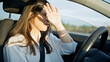 © Krakenimages.com - Young beautiful hispanic woman driving a car with sunlight on face on the road