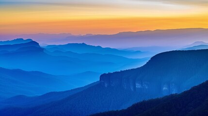 Wall Mural - The blue mountains in the distance, at sunset, with layers of peaks and dense forests below them