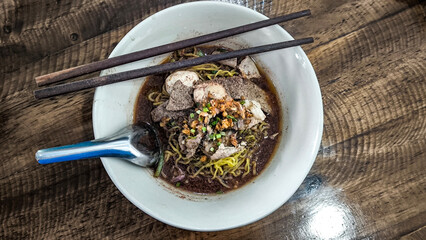 Wall Mural - Boat noodles in a pink bowl on a wooden table