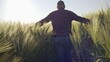 © procinemastock - Farmer walking through a field of growing barley