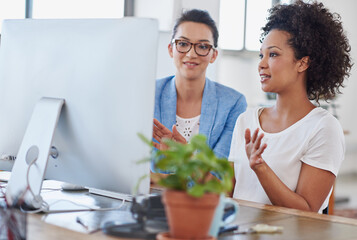 Wall Mural - Female people, coworker and computer in office for brainstorming, project or colleague as web designer. Women, technology and discussion for communication, teamwork or collaboration in digital agency