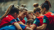 © PB Studio - A wide shot of a team huddle. Women from various backgrounds huddle together, strategizing and motivating each other before a crucial match. Their focused expressions and diverse physiques convey