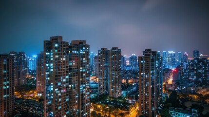 Wall Mural - Dramatic night view of illuminated high-rise buildings in a city skyline.