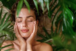 © carolina - woman using a soothing facial mist, surrounded by natural elements, copy space