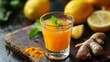 © fivan - A daily detox shot with ginger, turmeric, and lemon juice in a small glass