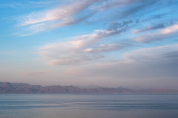 Wall Mural - Sunset clouds above Gulf of Aqaba of Red Sea. View from Dahab, Egypt.