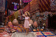 © Nataliya - a beautiful girl in dress in a traditional turkish interior with many carpets on the wall