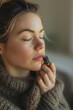 © smth.design - Woman Practicing Aromatherapy with Essential Oil in Cozy Sweater for Relaxation