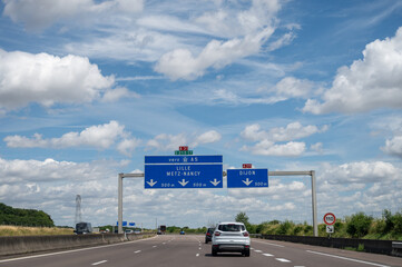 Wall Mural - Driving in summer on road, road signs direction to Lille, Nancy and other French cities, different types or roads in France, transportation and traffic