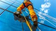 © IRStone - Alpinist is chalking glass construction of skyscraper. man climbing on glass wall with beautiful sky reflection