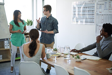 Canvas Print - Discussion, man and woman in office for meeting, team building and business or leadership. Collaboration, brainstorming and group or presentation in conference room for coaching or ideas for company