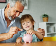 © Lumos sp - child money saving grandfather family coin senior finance bank piggybank happy investment grandson boy financial elderly cash