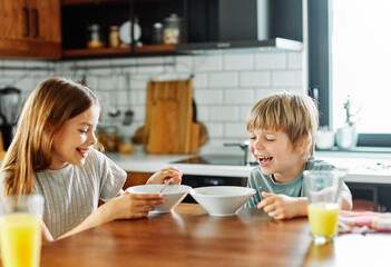 Wall Mural - child girl boy eating kid brother sister food breakfast kitchen together morning childhood dessert sweet oatmeal meal cereals love family together fun happy