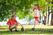 © famveldman - Family playing American football. Kids play rugby