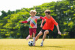 © famveldman - Child playing football. Kids play soccer.