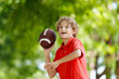 © famveldman - Family playing American football. Kids play rugby