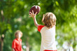 © famveldman - Family playing American football. Kids play rugby