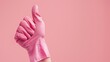 © Lasvu - Thumbs up in pink glove. Cleaning service concept with copy space.