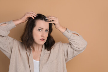 Wall Mural - Woman with hair loss problem on beige background