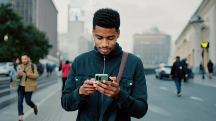 Poster - Young man walking street texting on phone