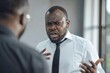 © Serhii - Mean Boss. Angry White Boss Arguing with Incompetent Black Employee in Corporate Setting