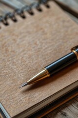 Poster - A pen sits on top of a notebook, ready to be used