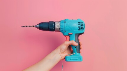 Aufkleber - A hand holding a blue cordless drill against a pink background