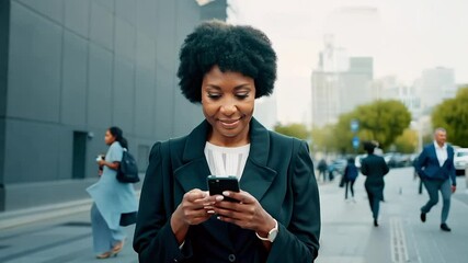 Wall Mural - Business woman walking street texting on phone