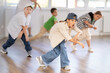 © JackF - Positive girls and boys training hip hop in dance studio, dance classes for kids