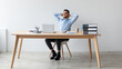 © Prostock-studio - Taking Break. Smiling young Arab man relaxing on chair sitting at table and resting, using pc laptop, happy millennial male leaning back at workplace, enjoying his job, feeling pleased and satisfied