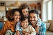 © GlooStock - A joyful family portrait featuring two parents and their two young children, all smiling brightly and embracing each other. The setting is a cozy, well-lit living room with warm, inviting decor. The p