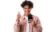 © The Stock Guy - Portrait of a smiling young man holding a phone and showing thumb up sign, isolated on transparent background