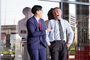 Wall Mural - Male businessman standing and smiling inside the office.