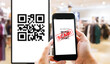 © panuwat - Fake QR Code scams fraud phishing concept. Man hands using smart phone