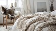 © Lasvu - Chunky merino wool blanket in cozy Scandinavian setting: bed, chair, white wall.