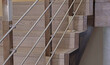 © AngArt - Laminate on stairs in house with handrails. Wooden overlays on sides of stairs. Iron bars. Construction and renovation.