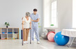 © Studio Romantic - A doctor at a rehabilitation center helps an elderly woman walk on crutches. Concept of the recovery process after surgery. Support for pensioners in a medical institution, specialized assistance