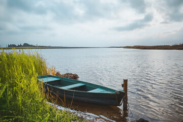 Naklejka na meble Calm waters with boat and cloudy skies