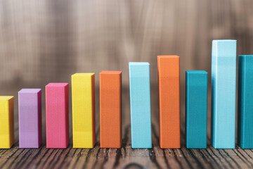 Poster - Colorful  bar graph illustration on a wooden background, showcasing data analysis, business growth, and financial trends in a visually appealing way.